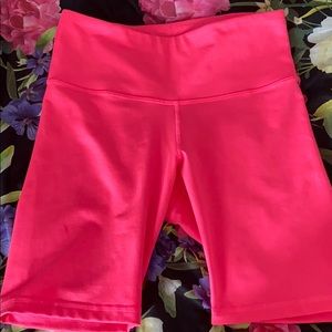 Neon pink biker shorts.